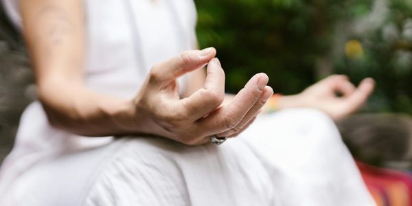Close up of hands in a mudra position during practice.