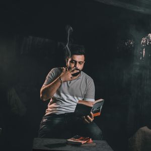 Incense smoke rising in a dimly lit room.