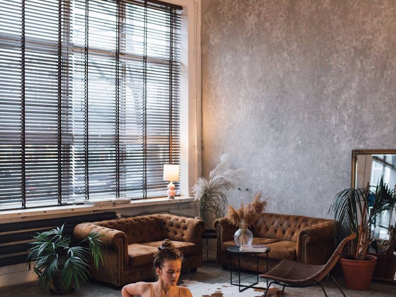 Minimalist yoga room with a single mat and soft shadows.